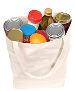 Reusable canvas bag filled with groceries on white background.